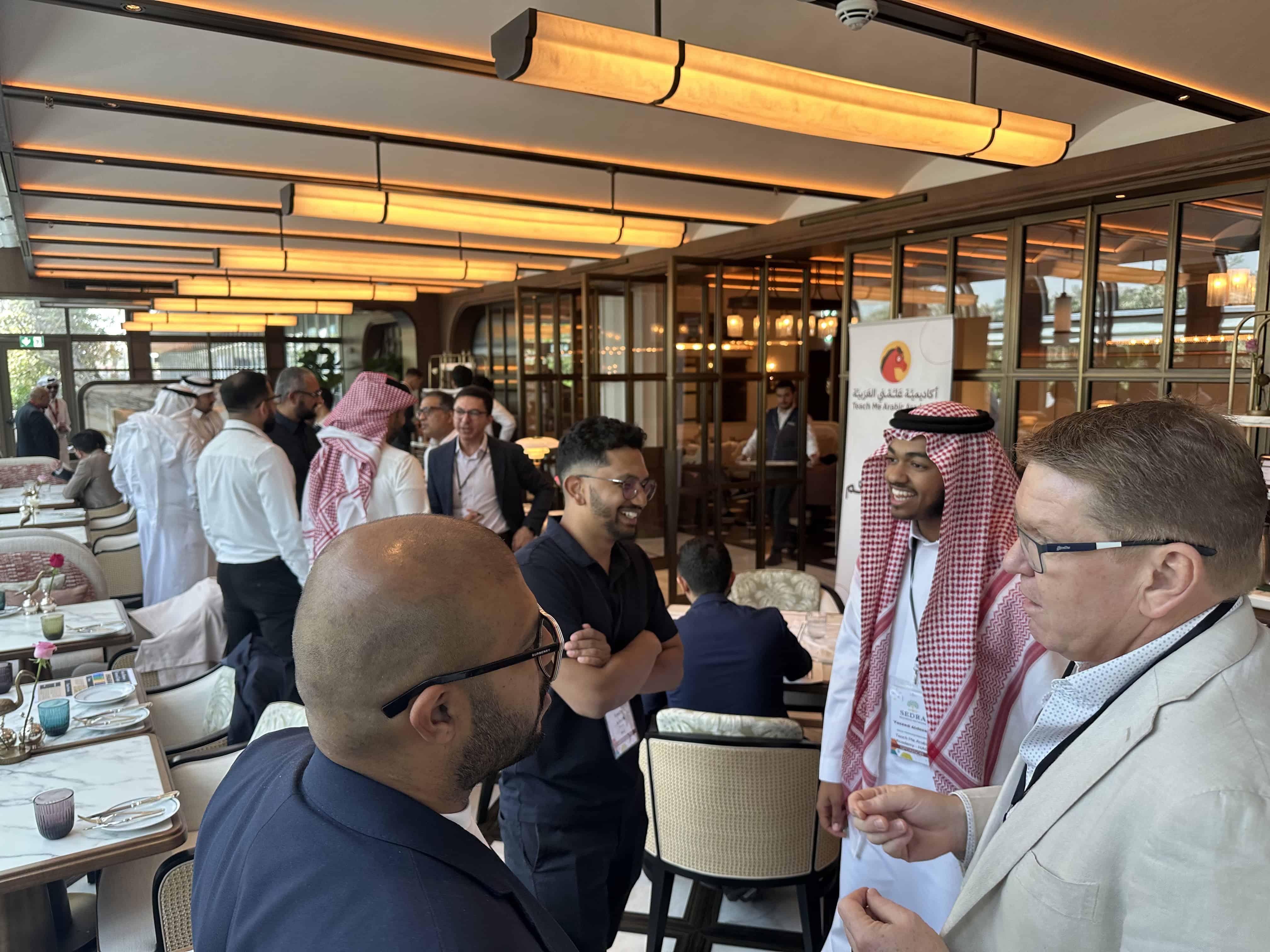 A member of Yahala's management team speaks with participants during the Sedra Business Network (SBN) event.