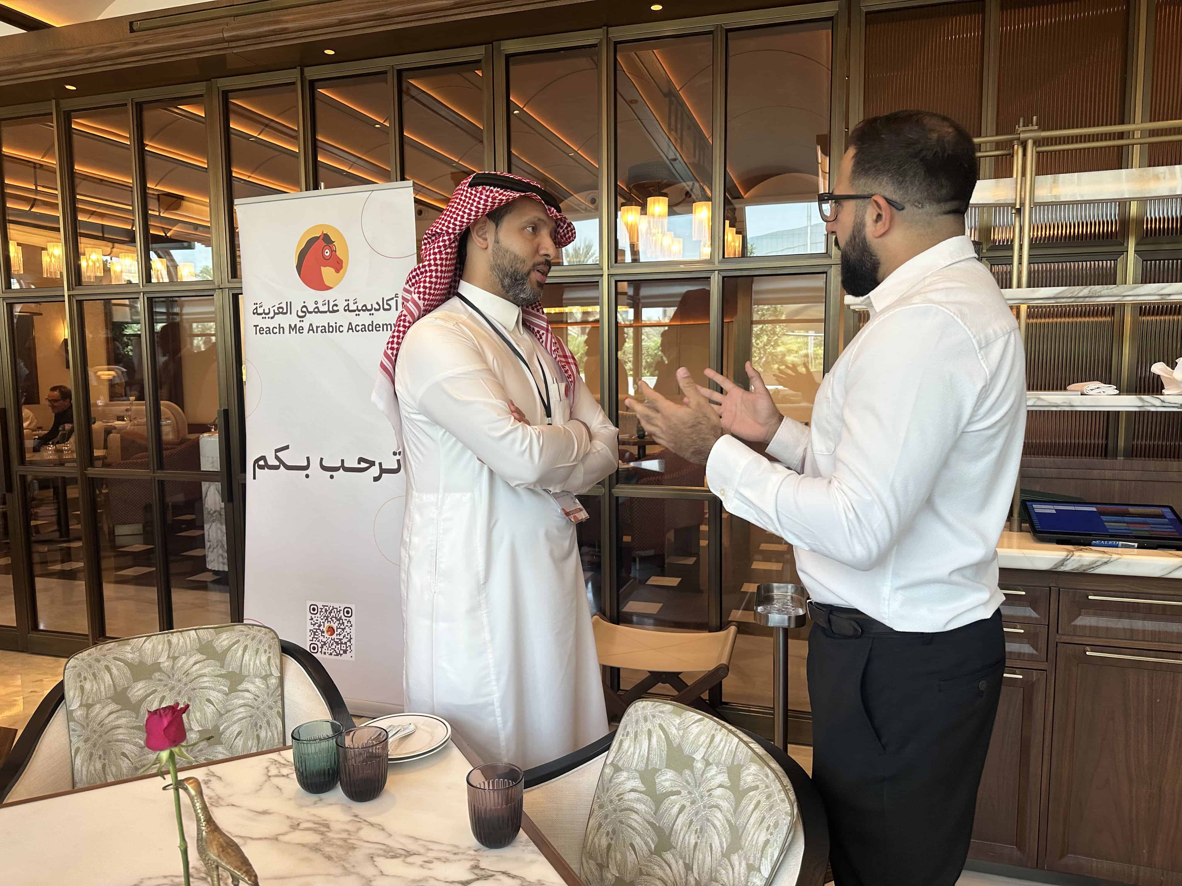 A Yahala staff member speaks with a participant during the Sedra Business Network (SBN) event.