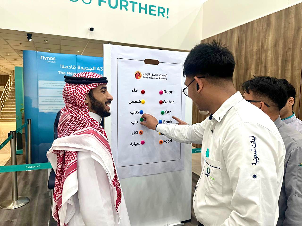 flynas employees participating in an interactive Arabic language activity on World Arabic Language Day